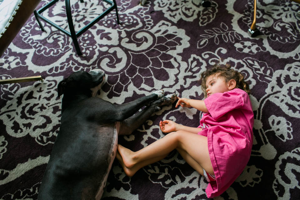 girl lays next to napping dog - Documentary Family Photography