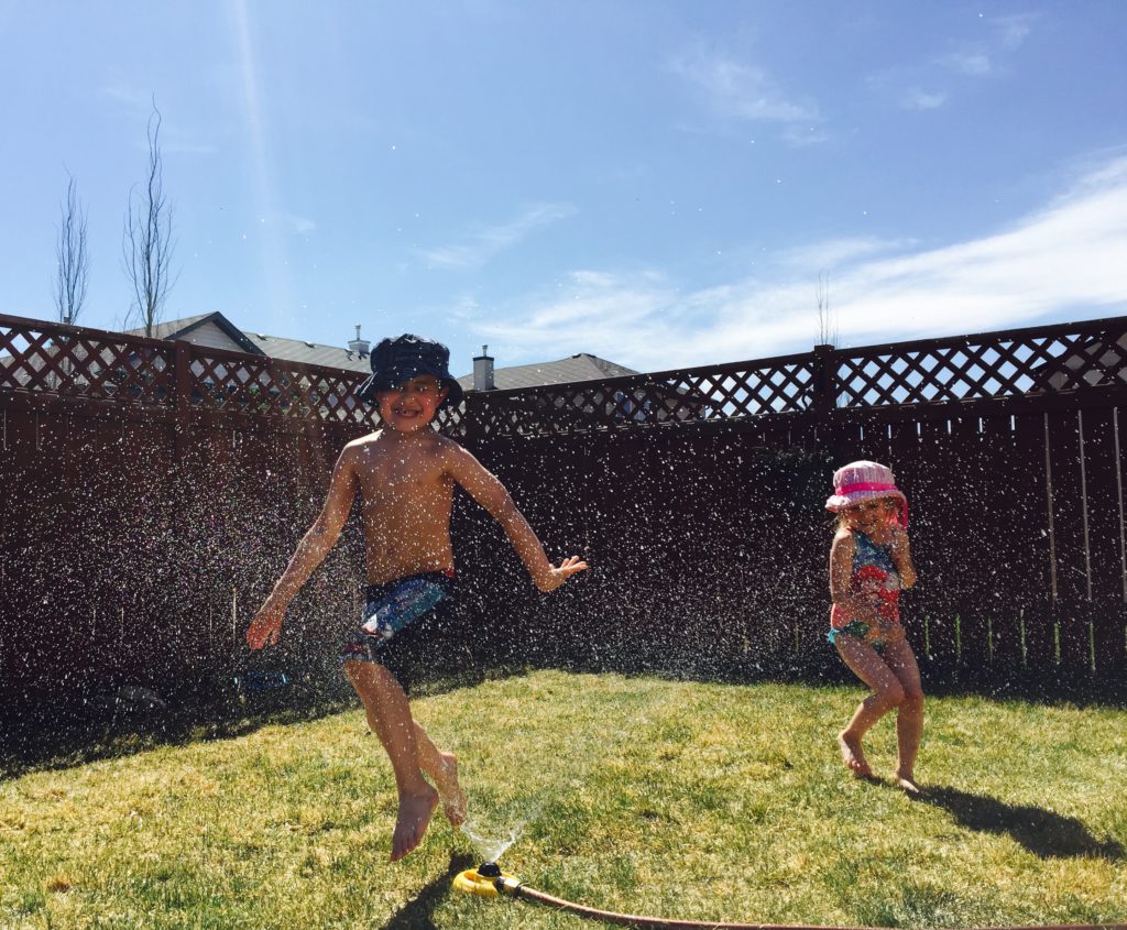 kids play in sprinkler - documentary family photography