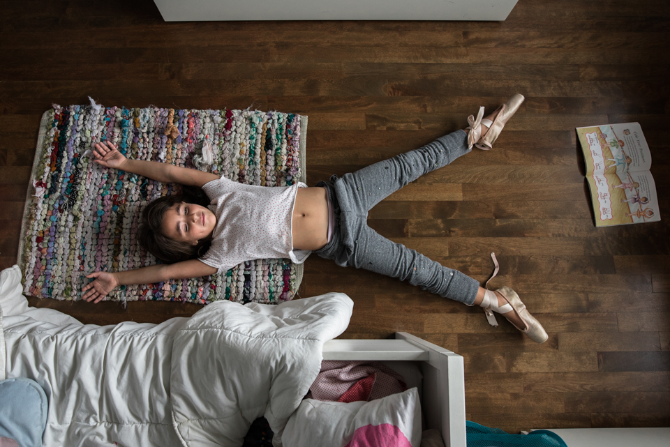 girl lays on floor - Documentary Family Photography