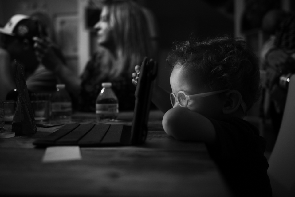 boy sits at table -Documentary Family Photography
