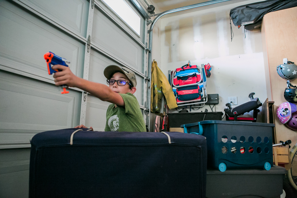 kids play with nerf guns in garage - Documentary Family Photography