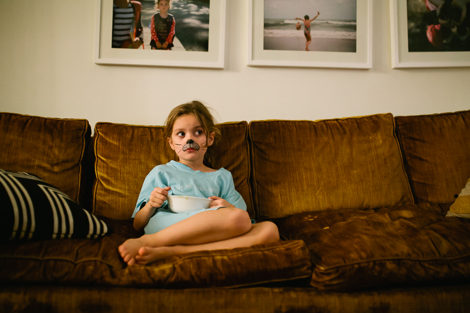 girl on couch with facepaint - Documentary Family Photography