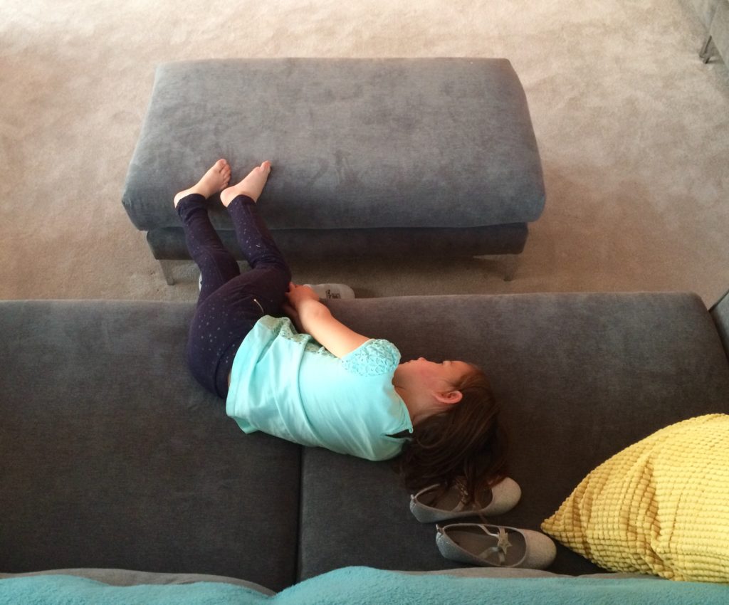 girl lays on couch - Documentary Family Photography