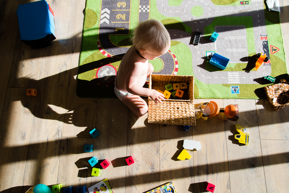 baby with blocks in sunlight - Documentary Family Photography