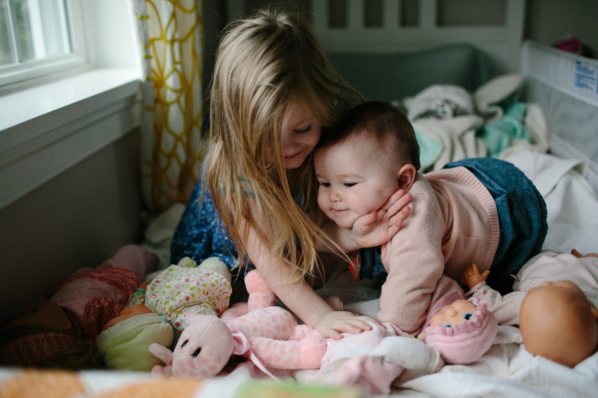little girl hugs baby - Documentary Family Photography