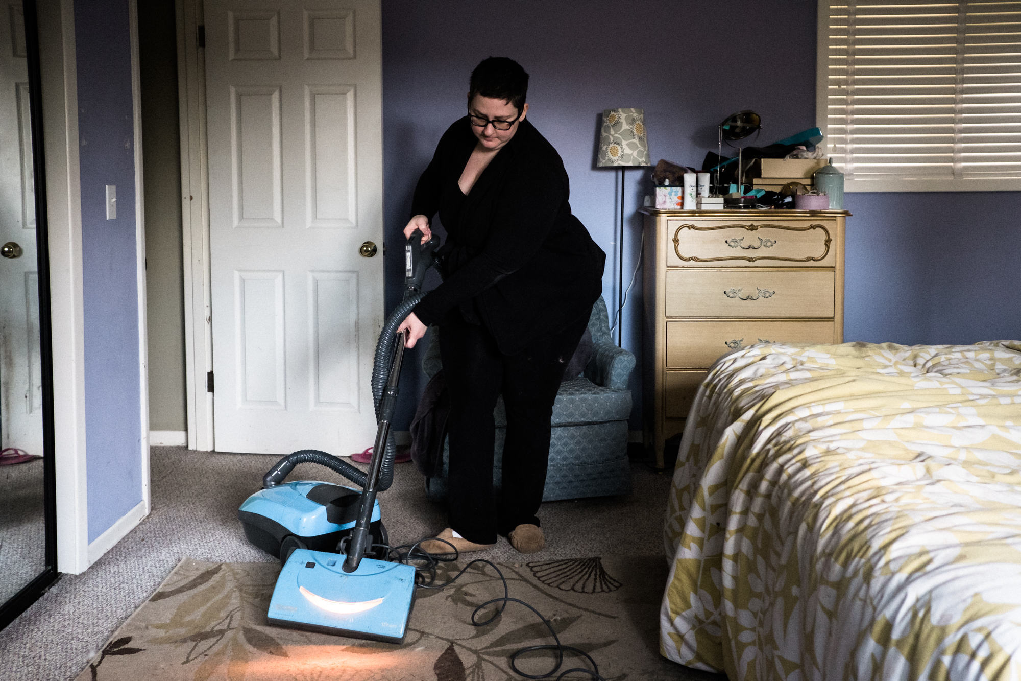 woman vacuuming - documentary family photography