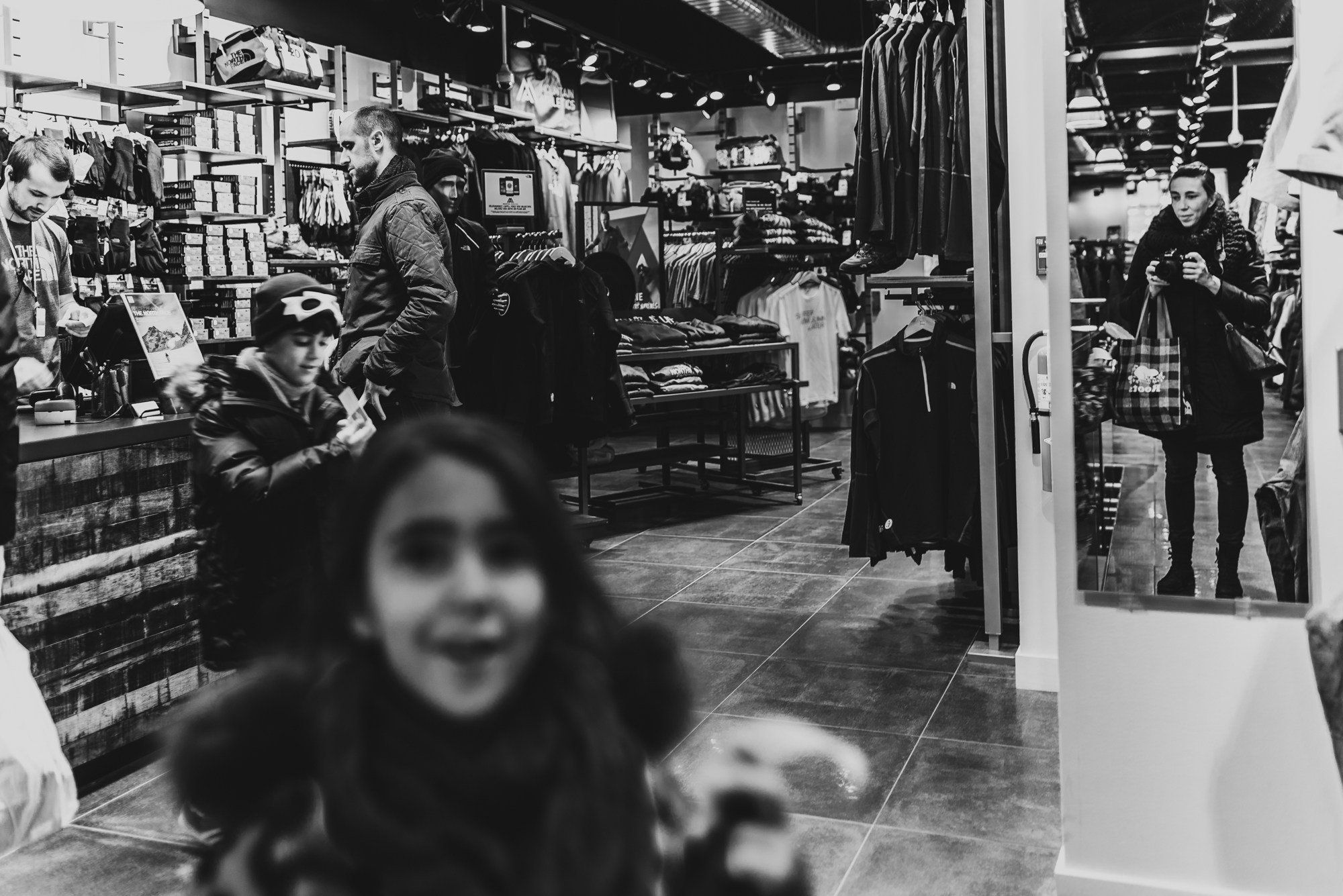 self portrait of woman in mirror in shop - documentary family photography