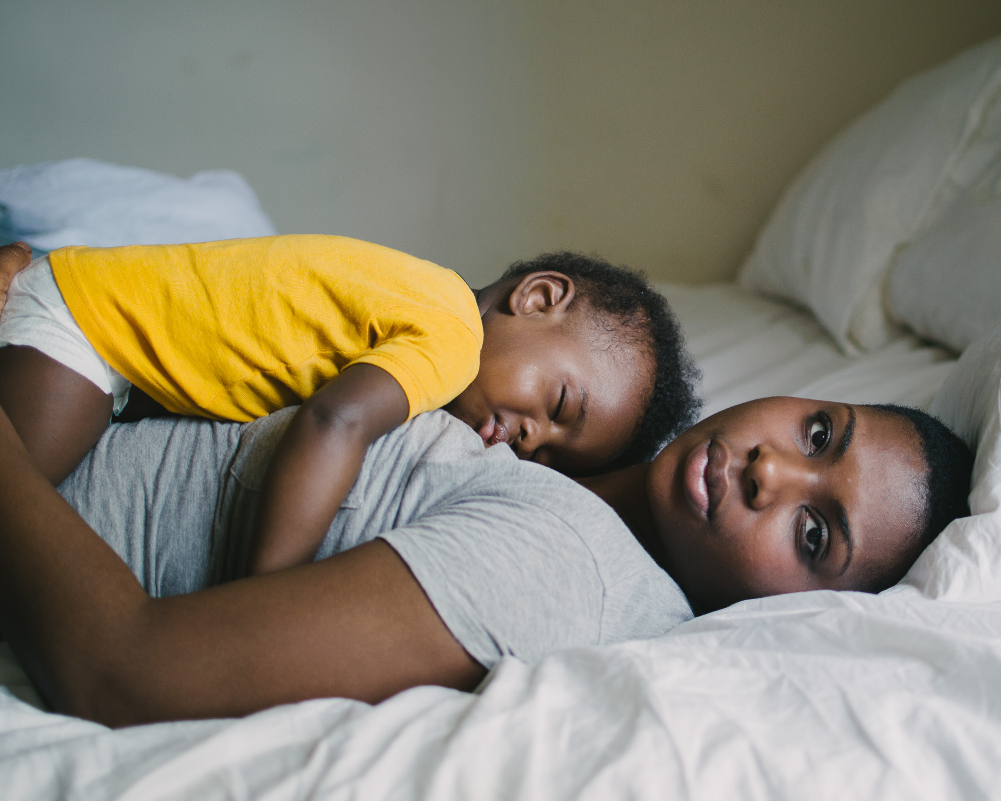 woman on bed with child - documentary family photography