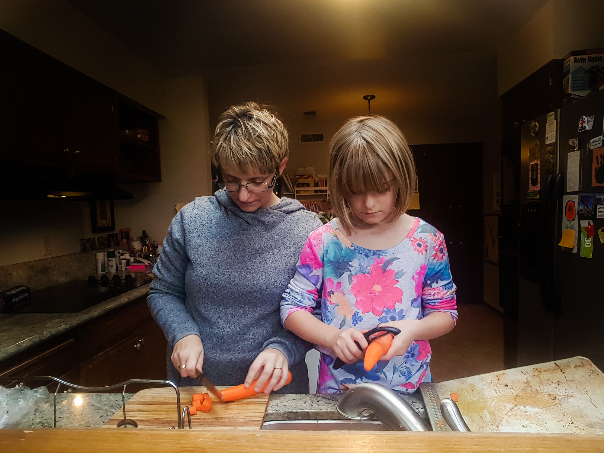 mother cooks with daughter - documentary family photography