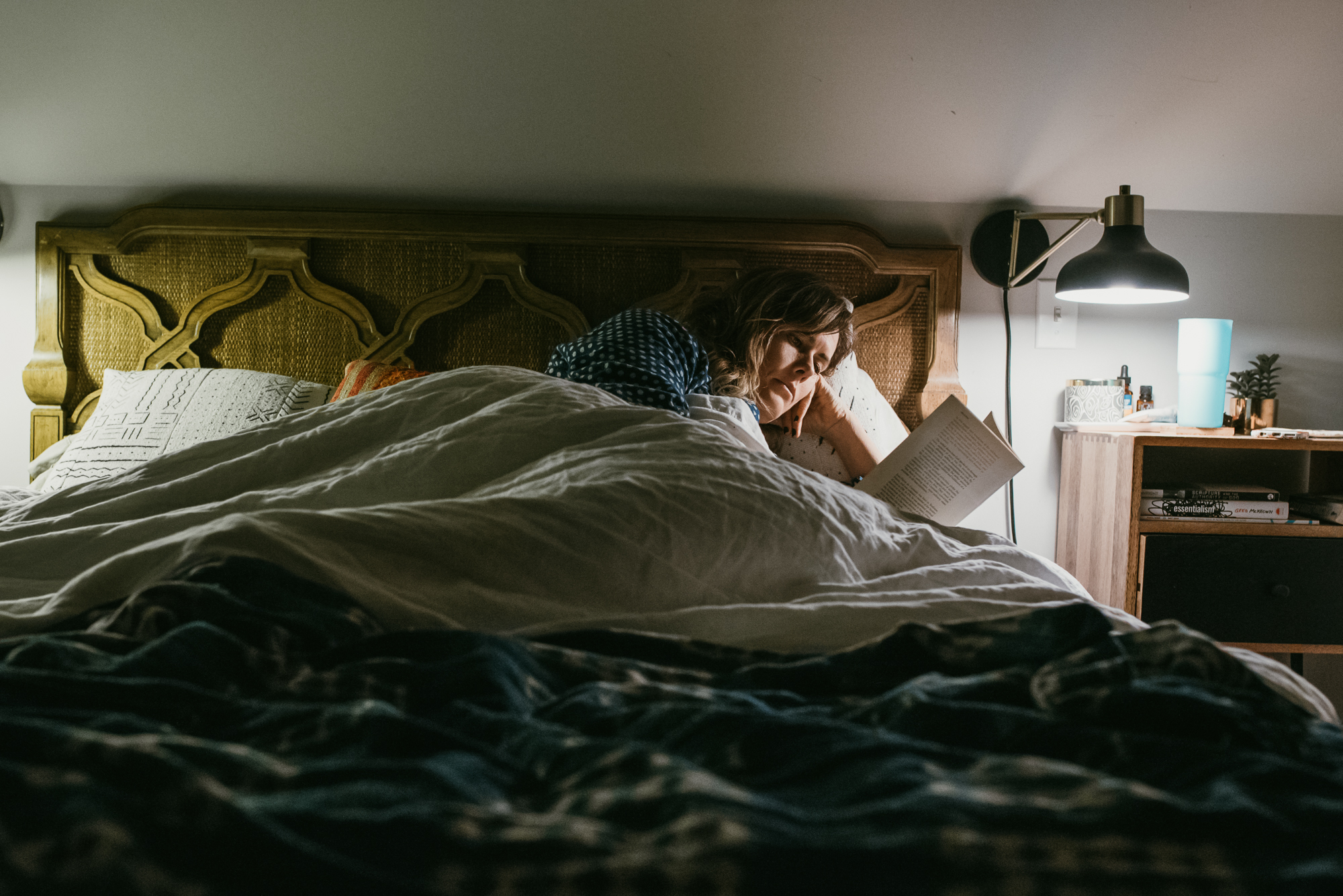 woman reading in bed - documentary family photography