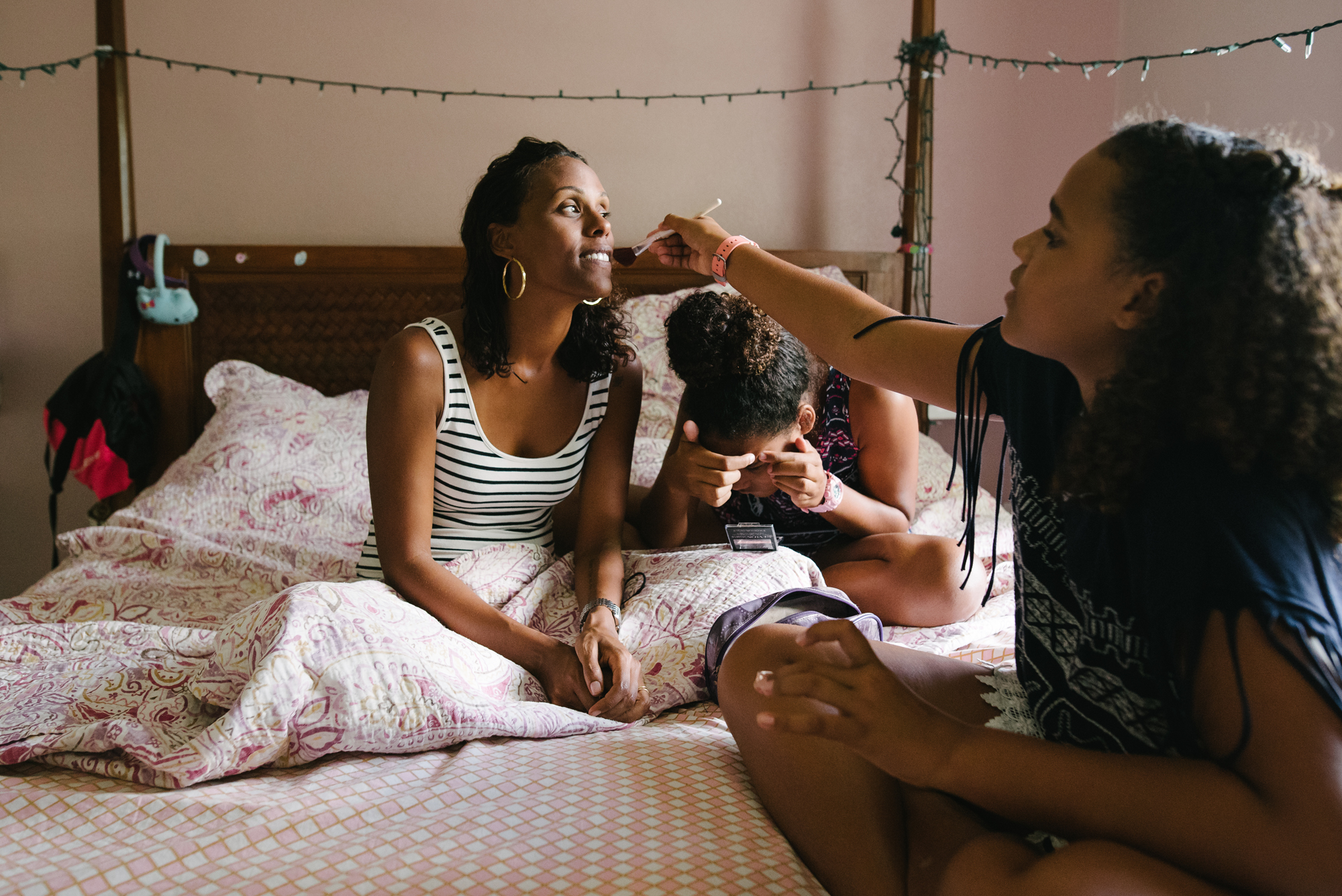 daughters put makeup on mother - documentary family photography