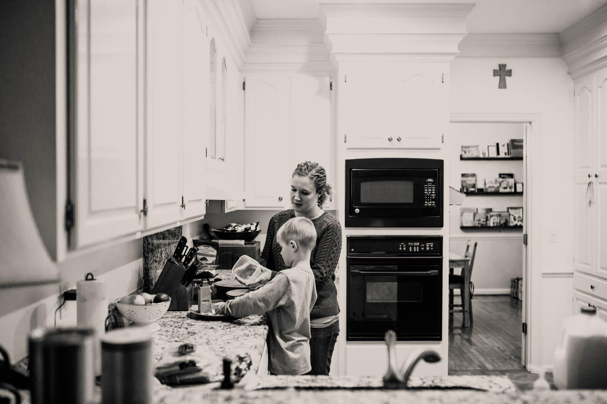 mother cooks with son - documentary family photography
