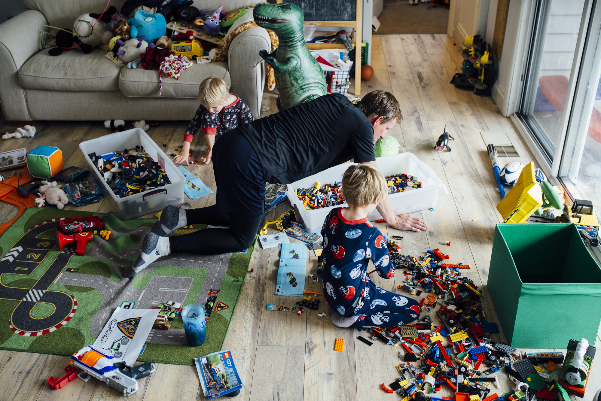 father and kids play with legos - documentary family photography