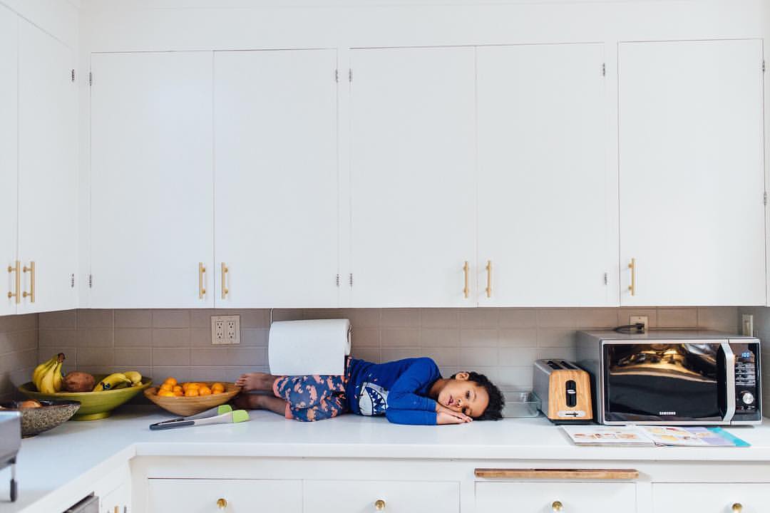 boy asleep on kitchen counter - documentary family photography