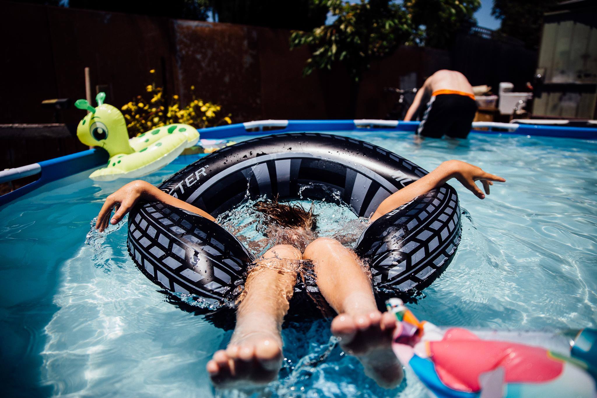 child splashes in pool - documentary family photography