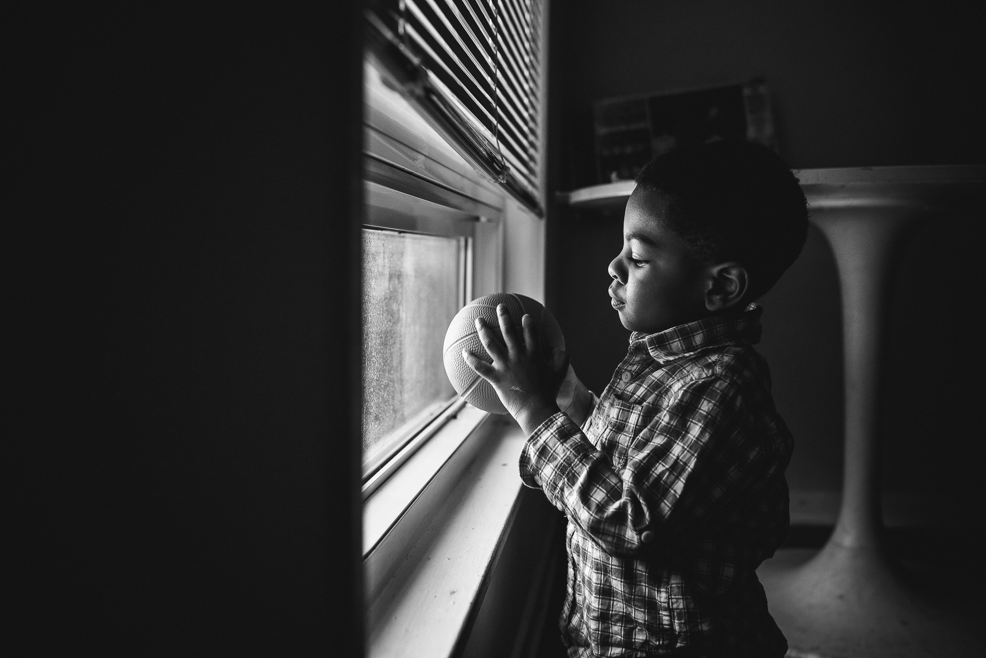 boy with ball at window - documentary family photography
