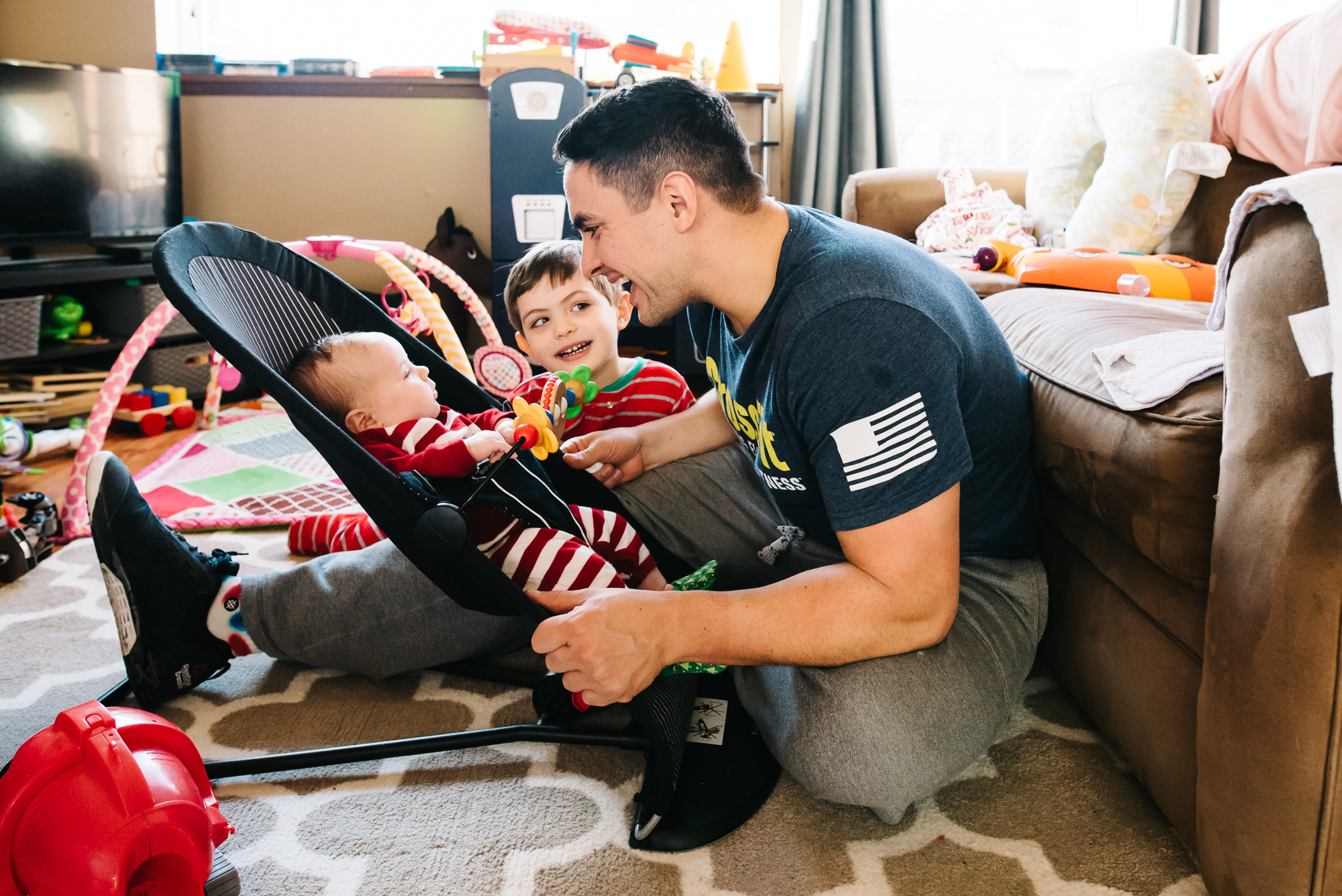 father plays with baby and son - documentary family photography