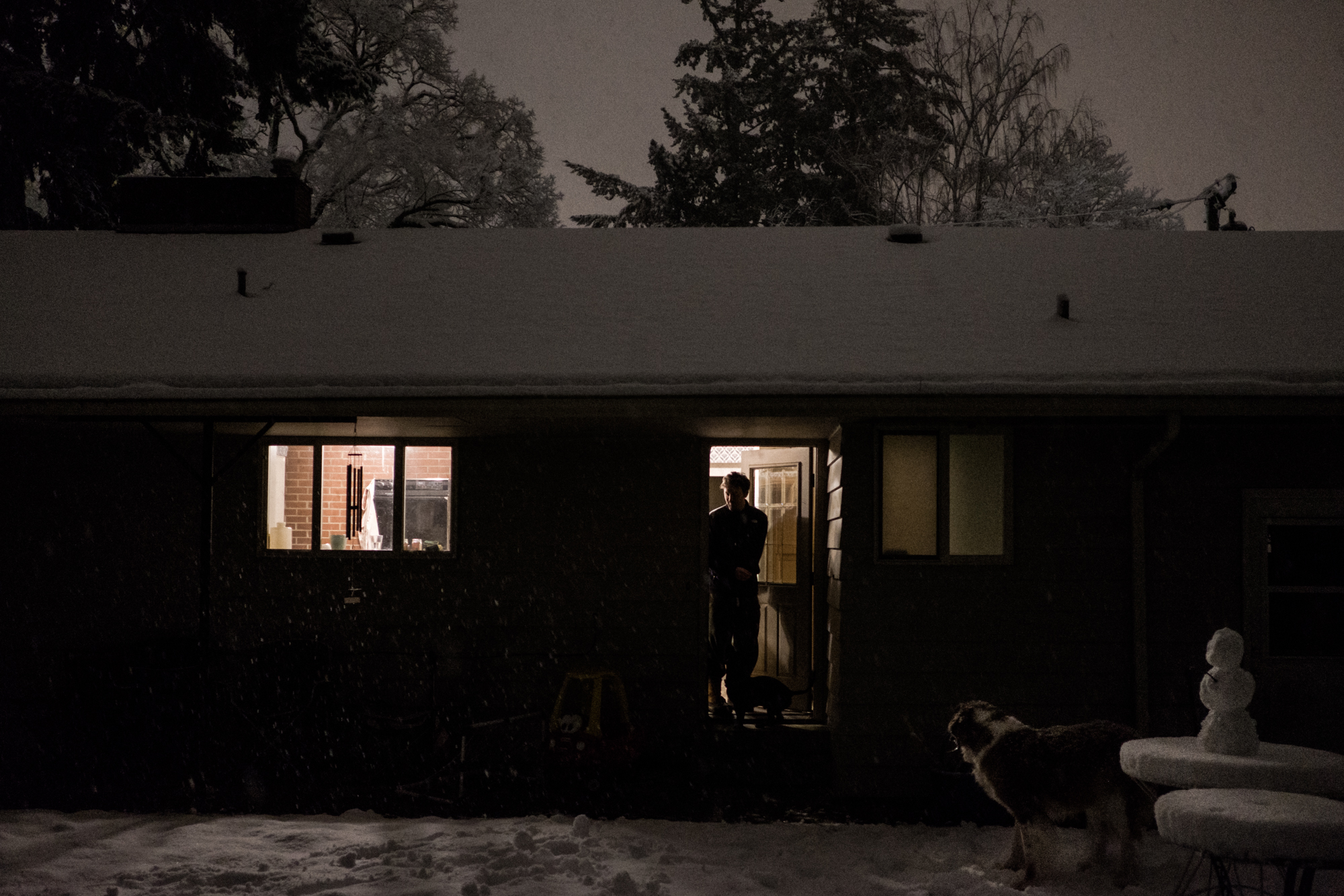 Man lets dog out at night -documentary family photography