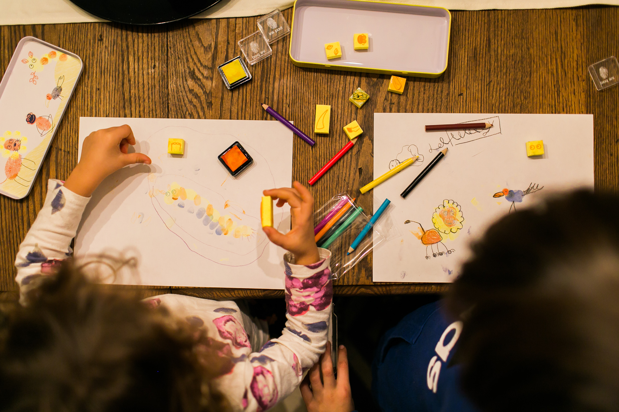 kids play with stamps - documentary family photography