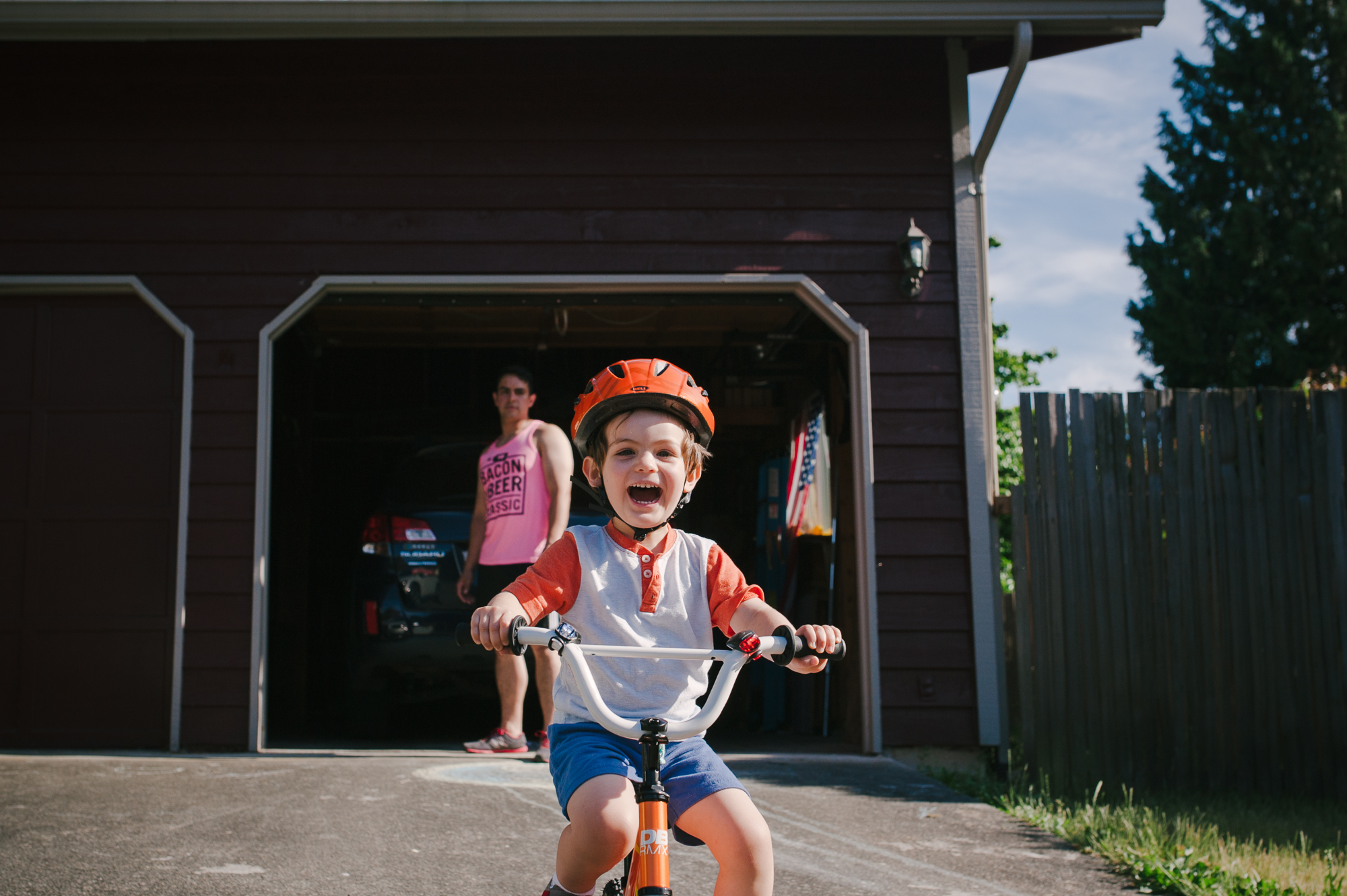 boy rides bike in driveway