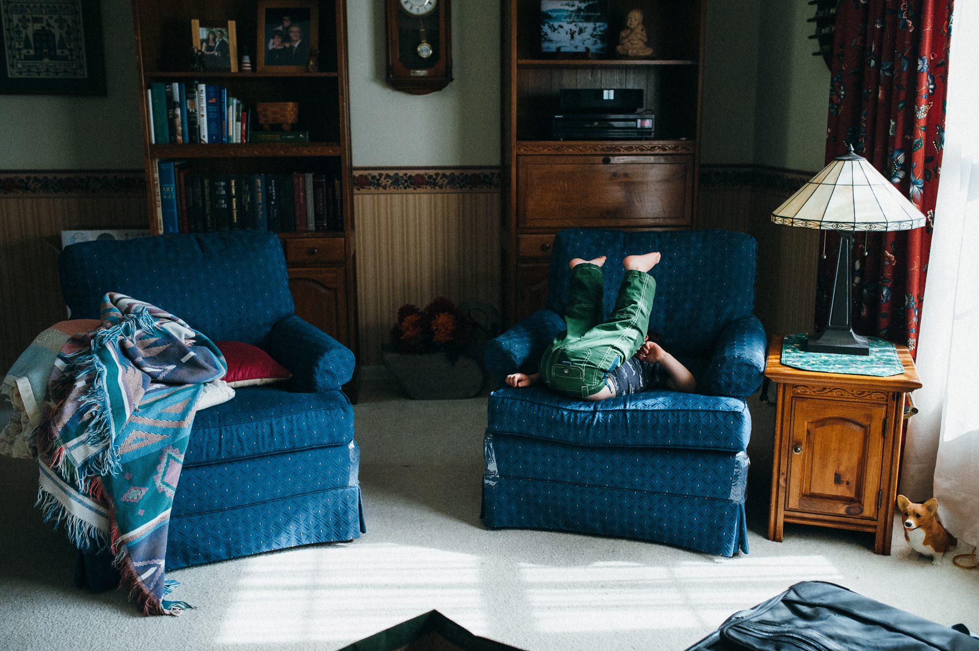 boy kicks up feet in chair