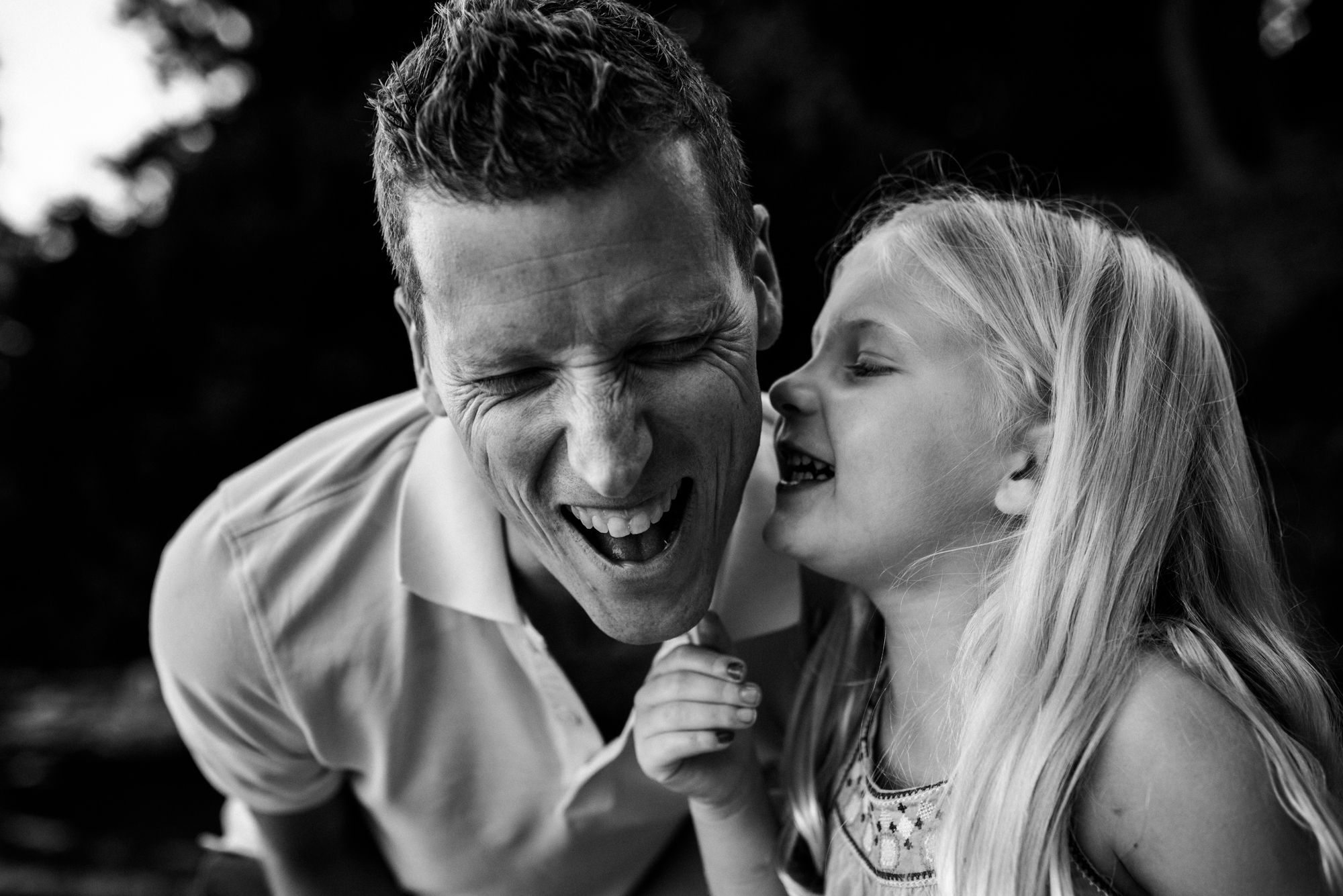 Father anticipating a kiss on the cheek from his daughter