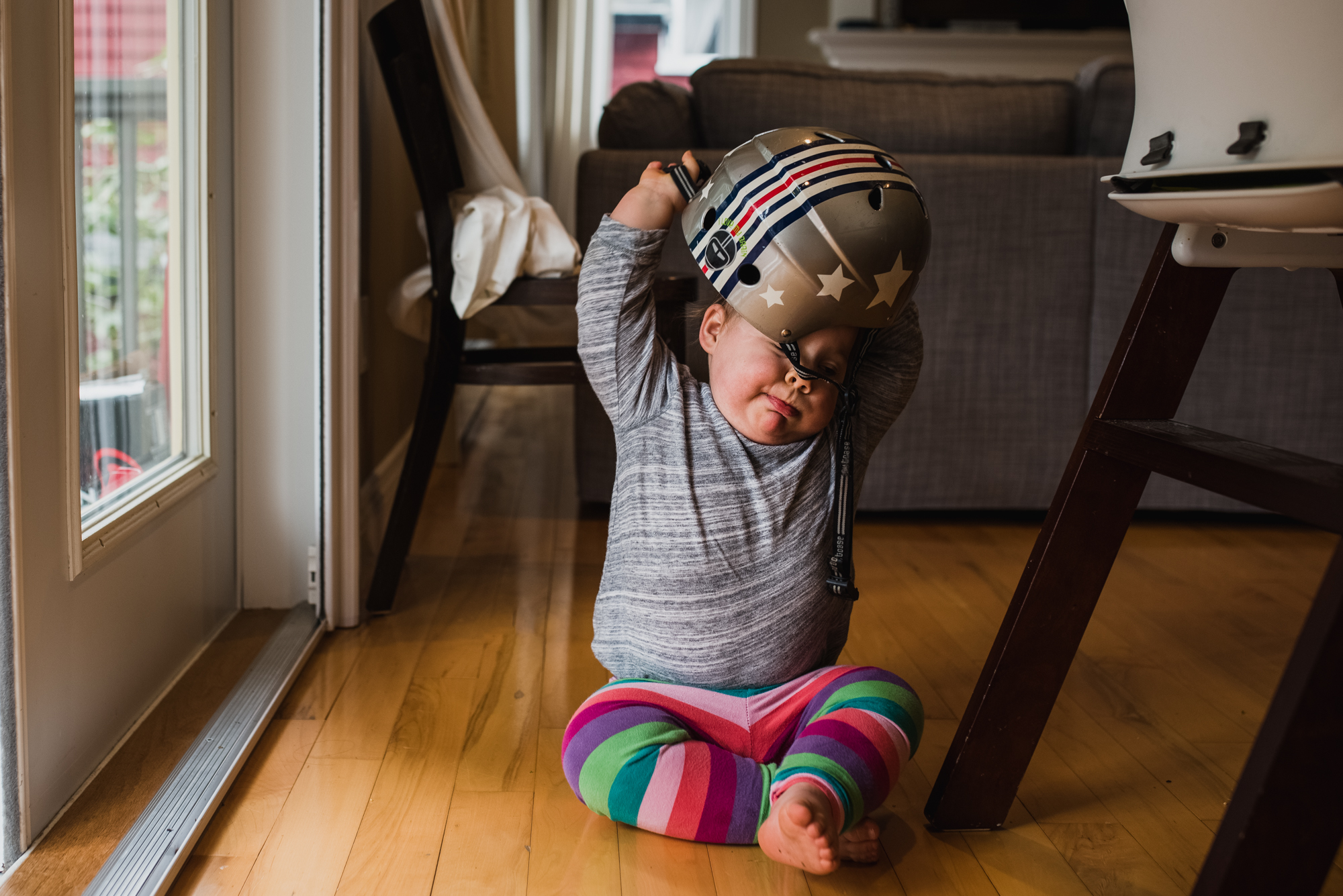 Toddler trying to remove a helmet off her head