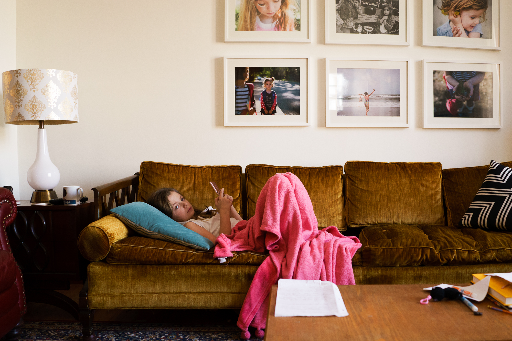 girl with phone on couch - Documentary Family Photography