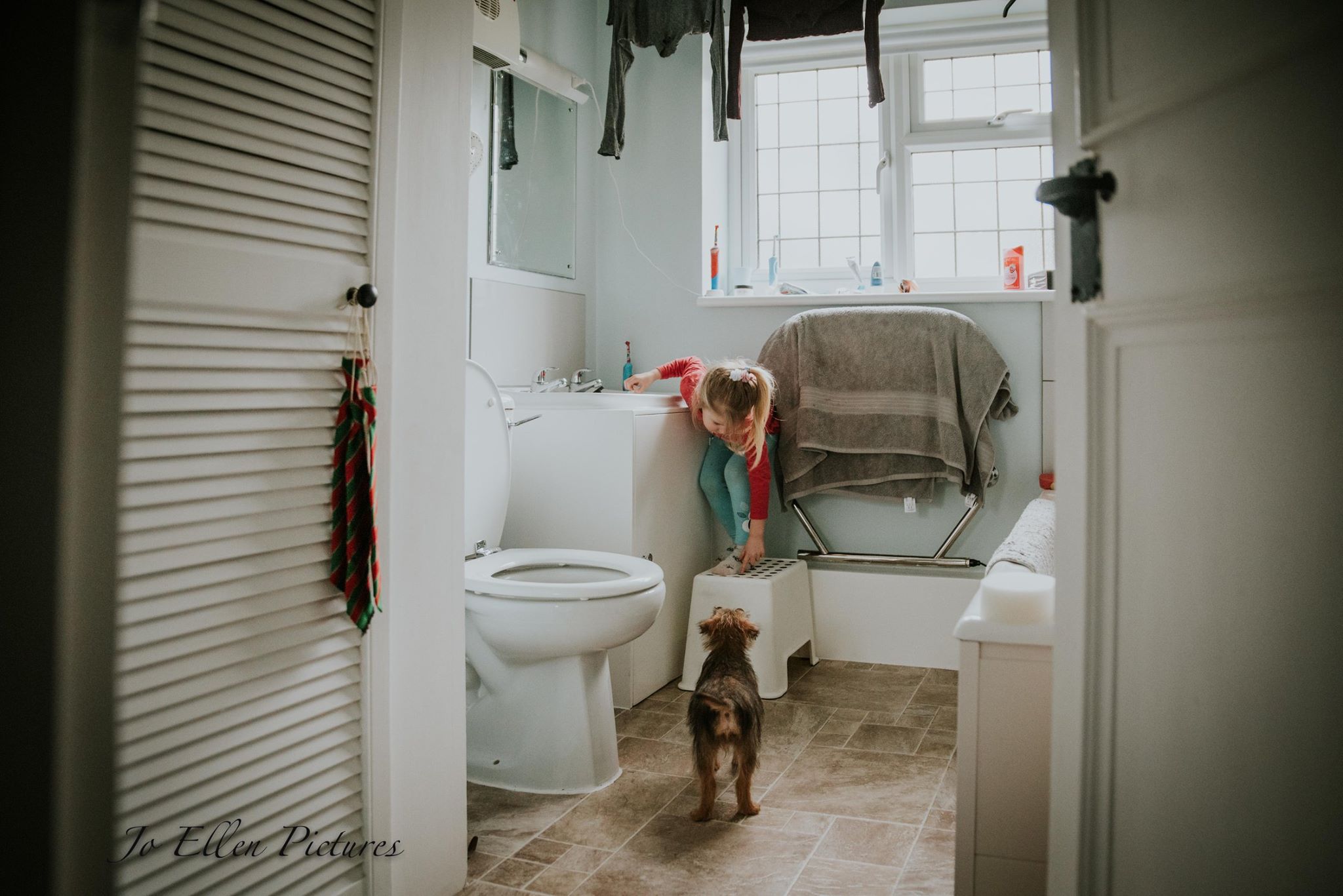 girl with dog in bathroom - Documentary Family Photography