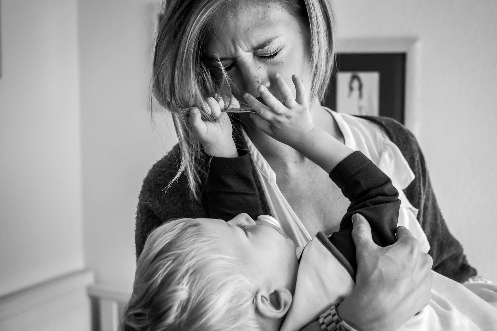 baby pulls mother's hair - Documentary Family Photography