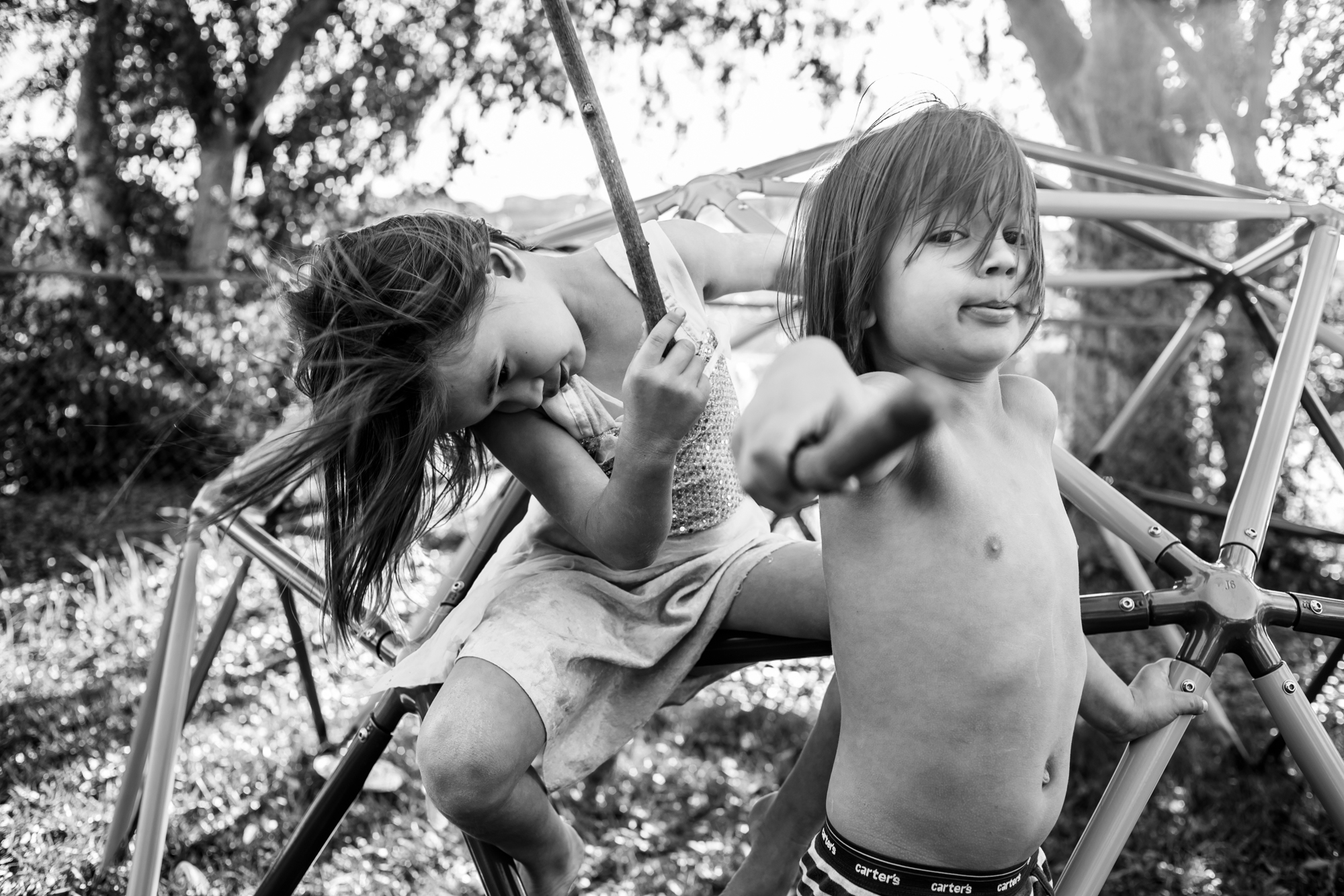 kids play on swing and play with sticks