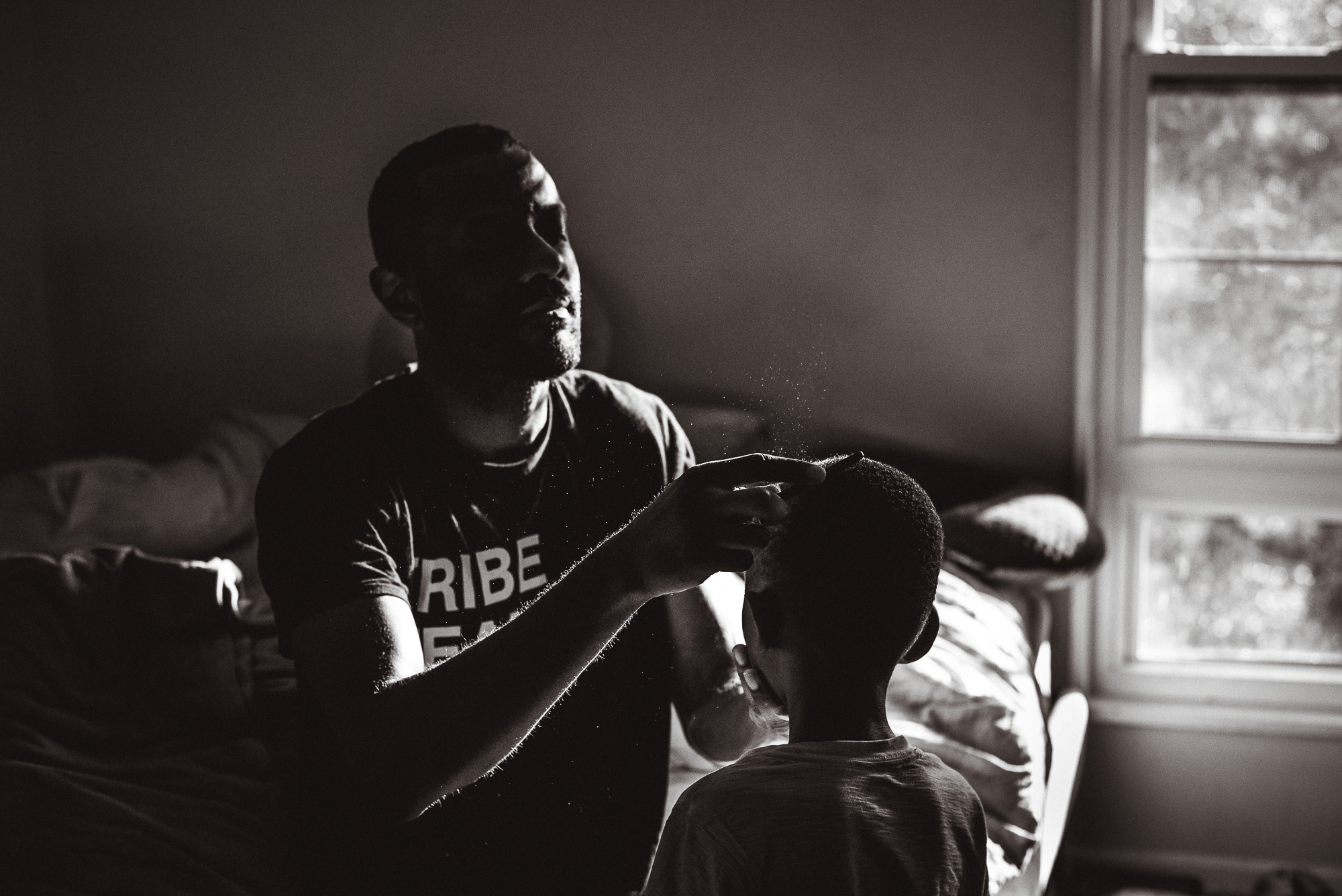 father brushes sons hair - Documentary Family Photography
