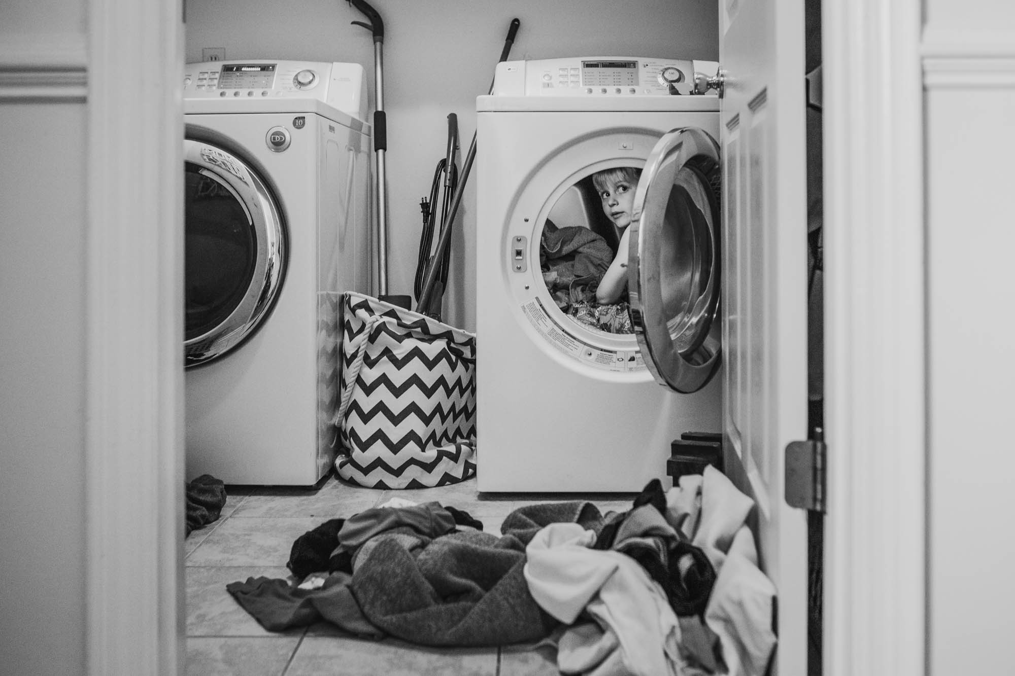 child hides in dryer - Documentary Family Photography