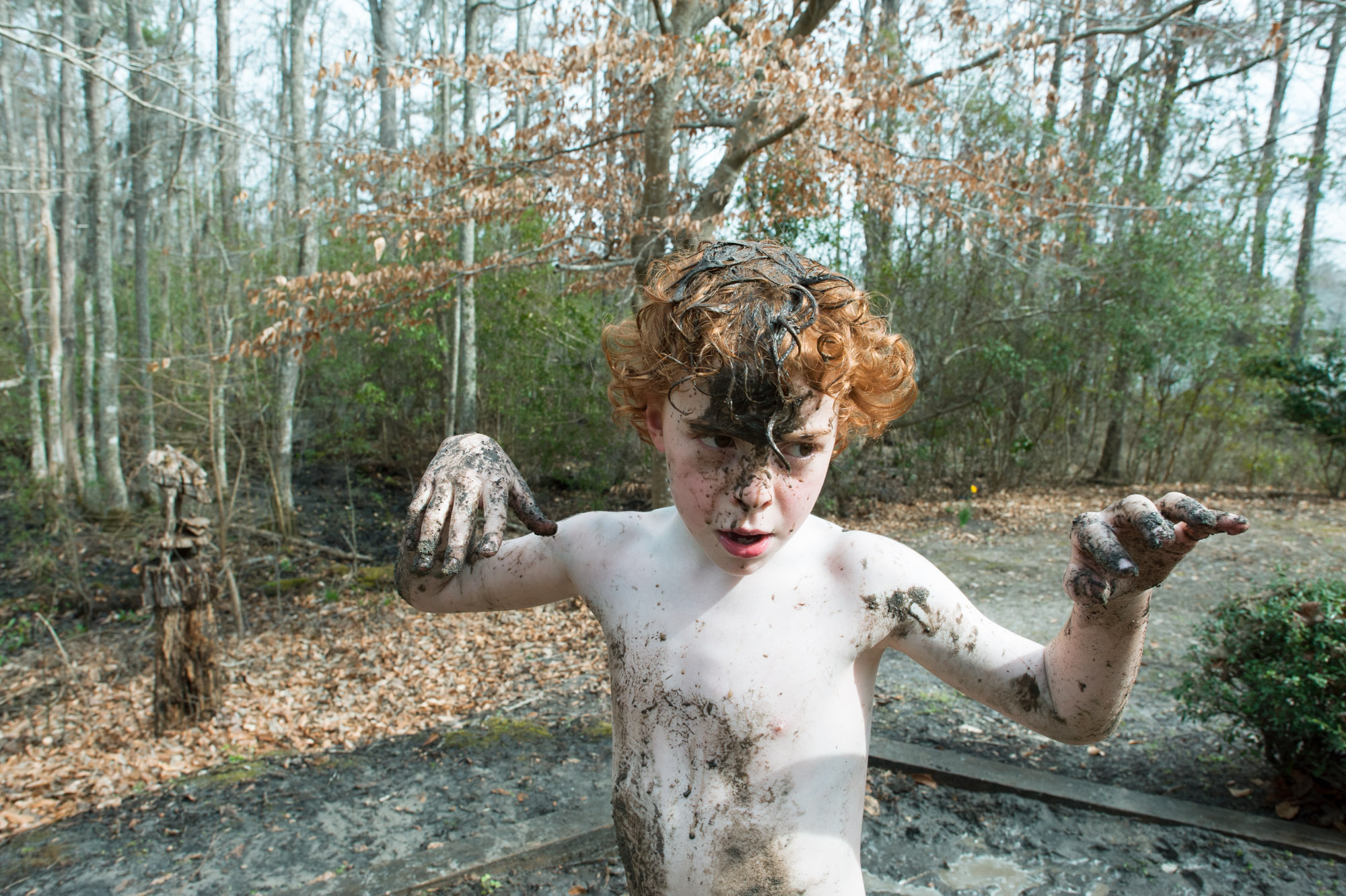 boy plays in mud - Documentary Family Photography