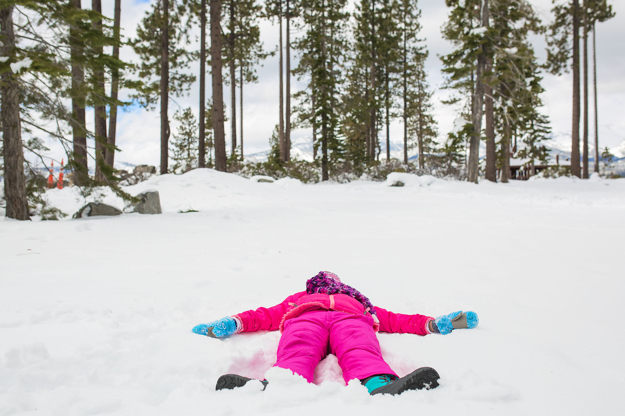 girl making snow angel - Documentary Family Photography