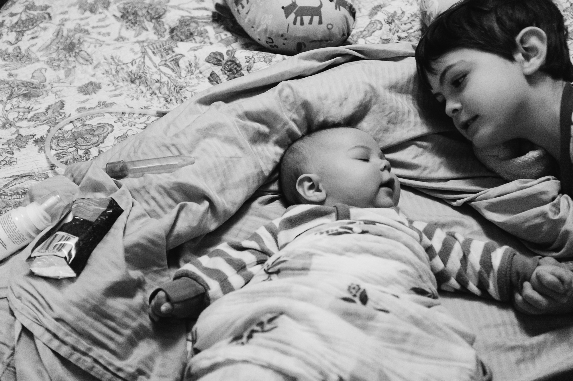 boy on bed with baby - Documentary Family Photography
