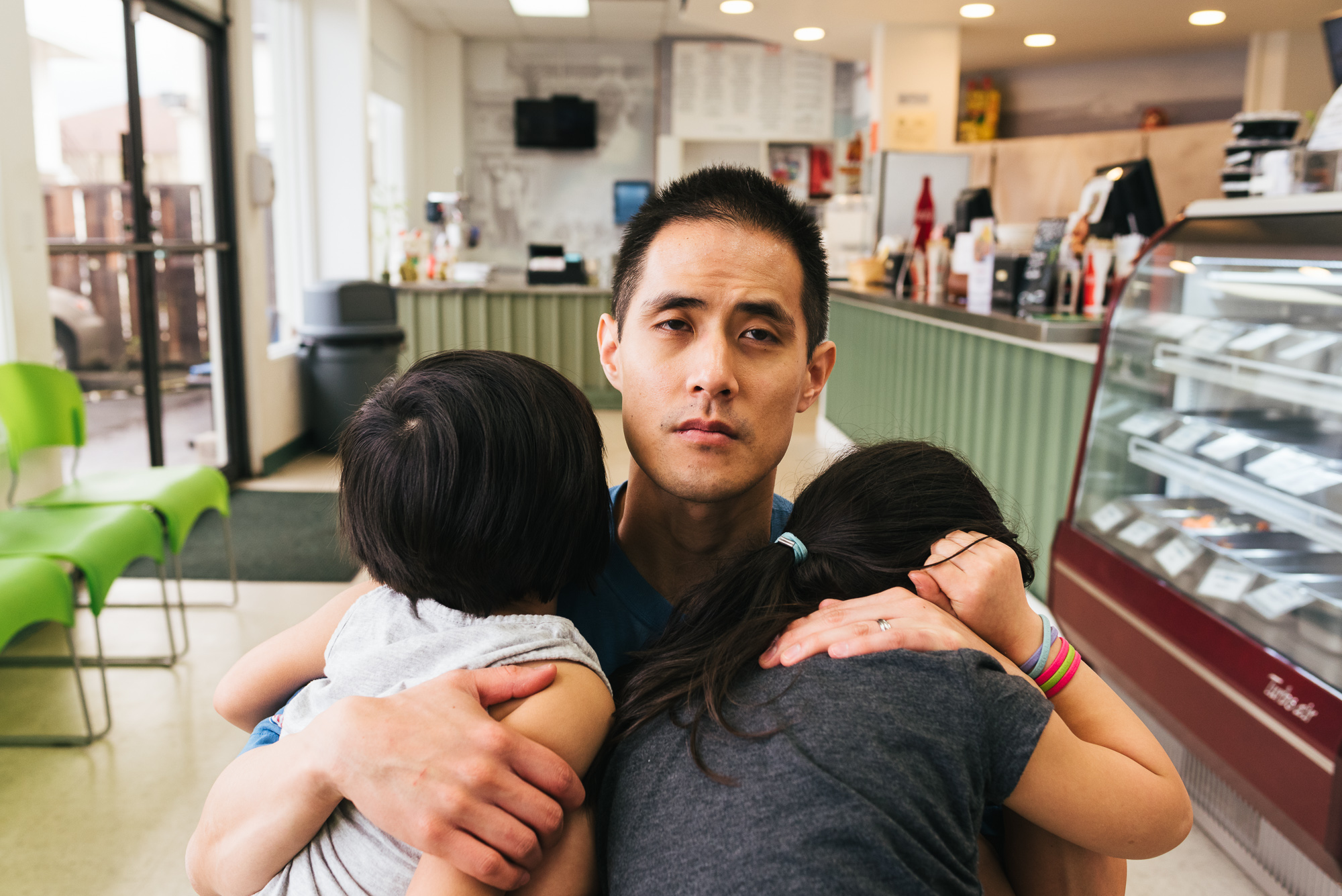 tired father holds children - Documentary Family Photography