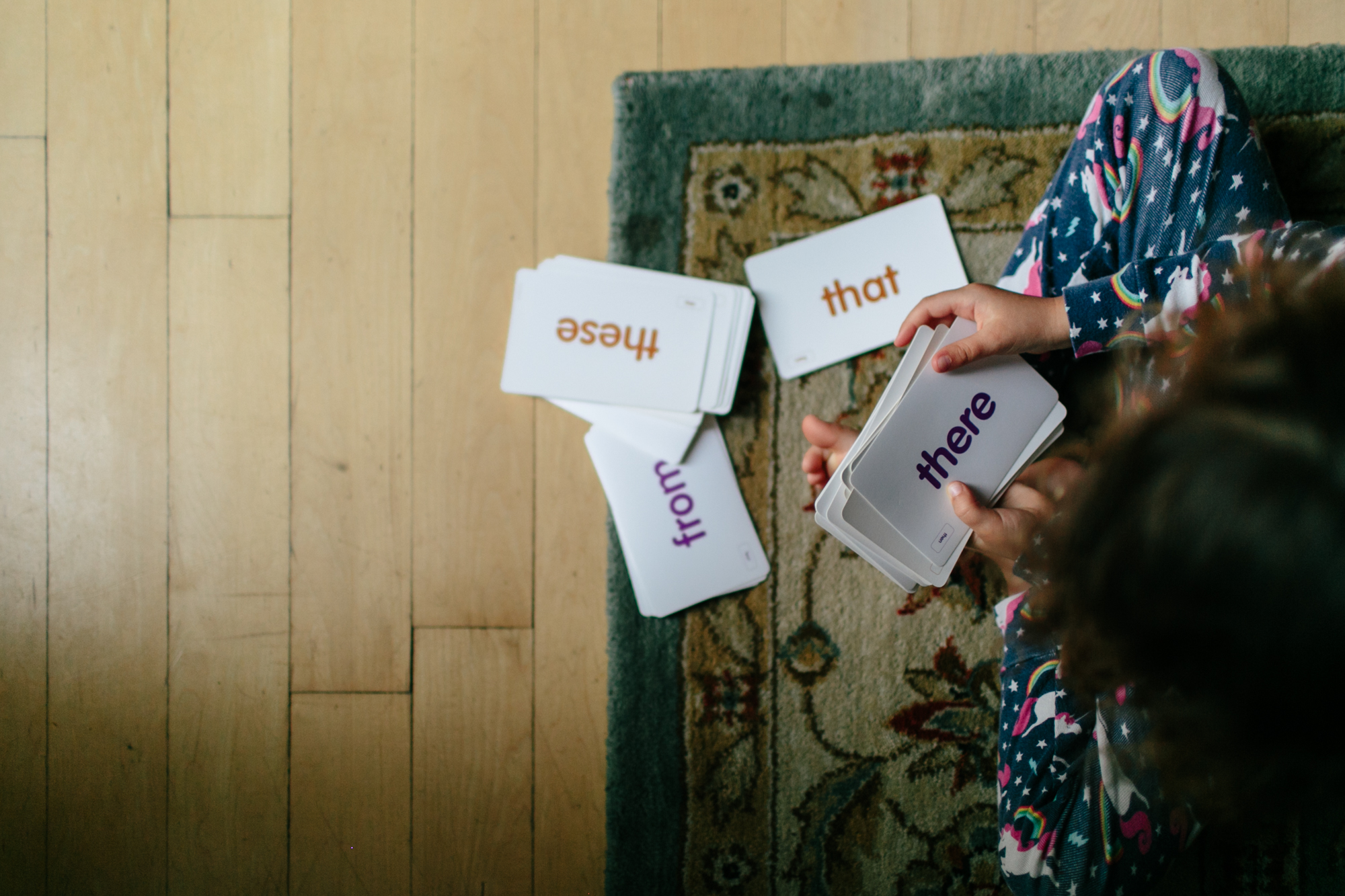 child with flash cards - Documentary Family Photography