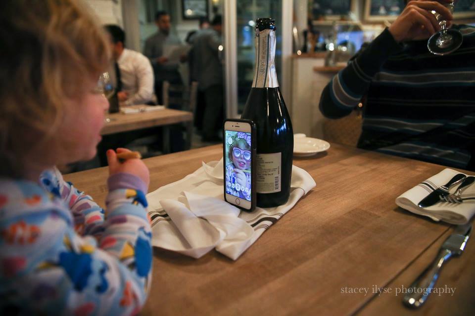 kid plays on phone - Documentary Family Photography