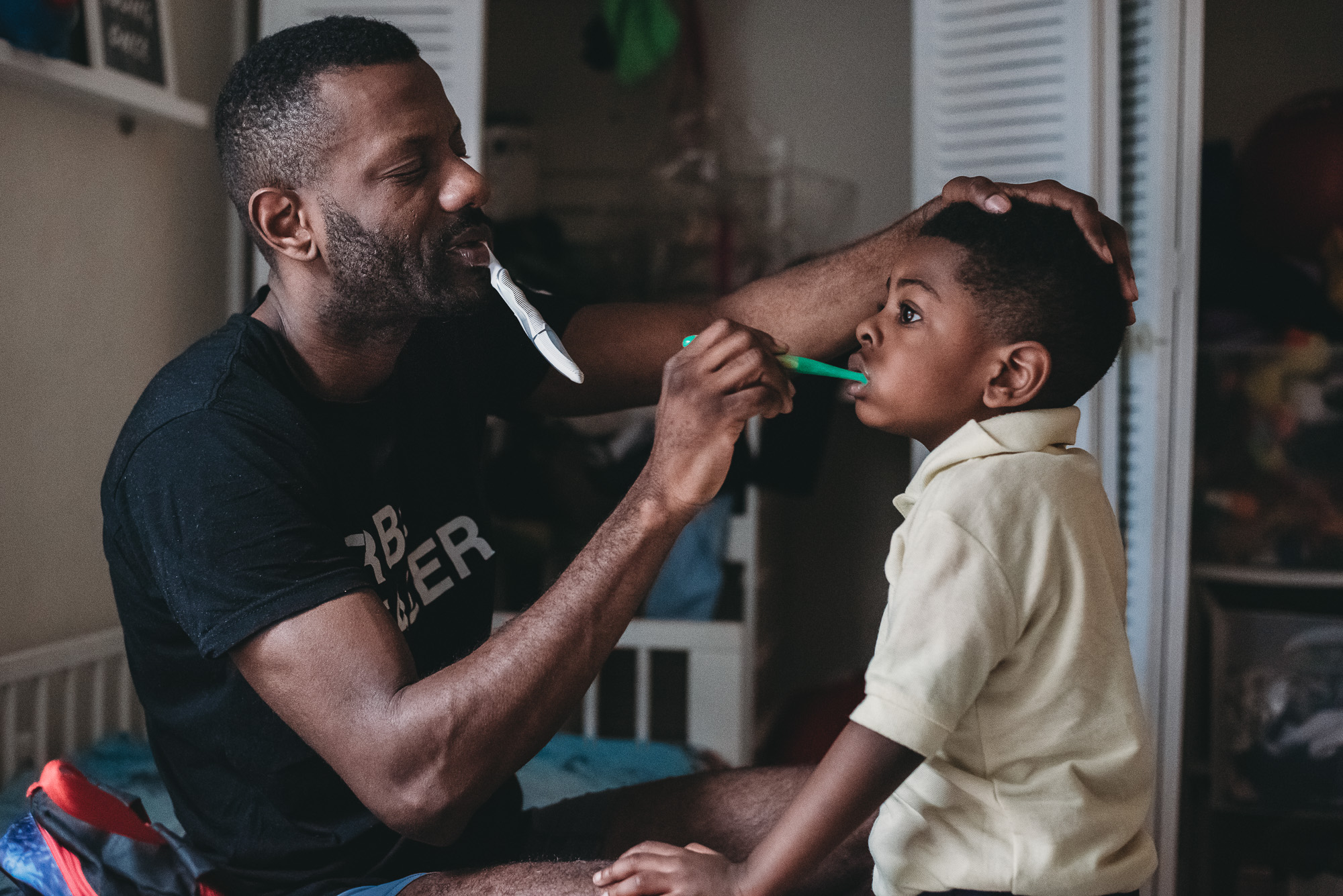 father brushes son's teeth - Documentary Family Photography