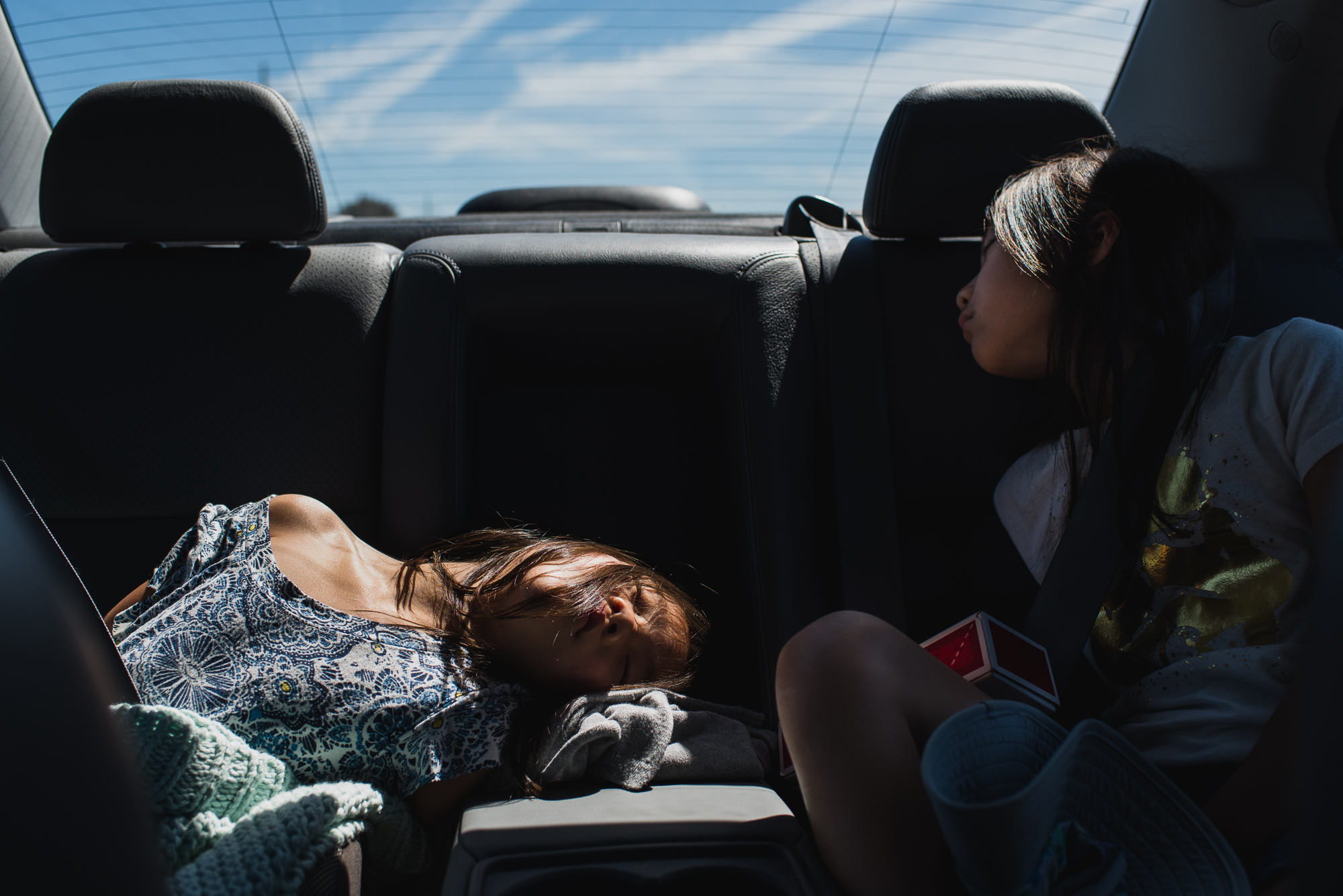Girls asleep in the back of the car - Documentary Family Photography