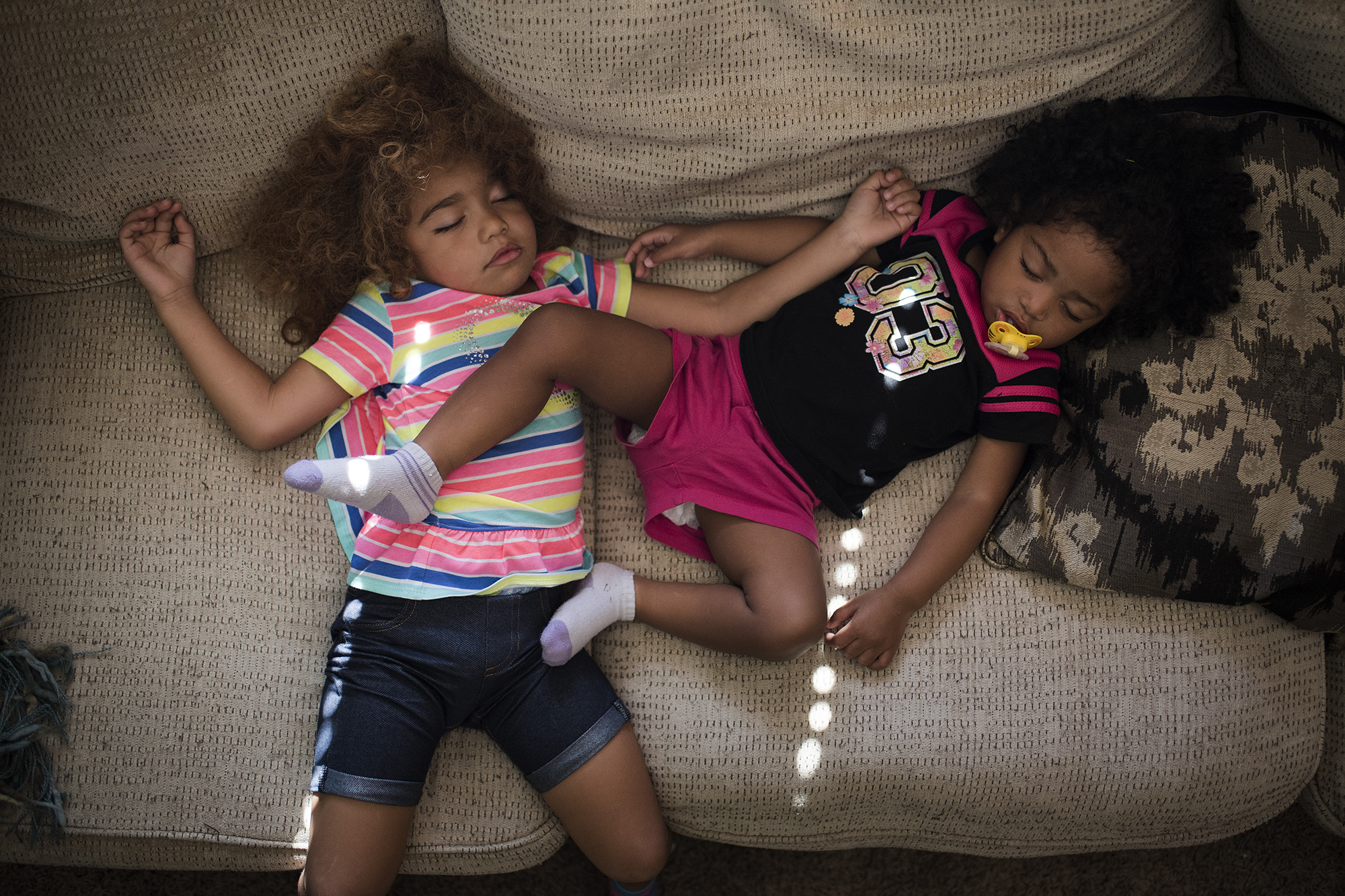 girls asleep on couch - Documentary Family Photography
