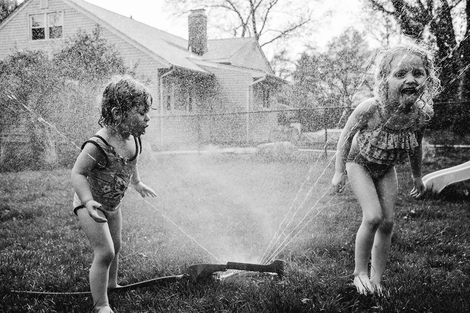 kids in sprinkler -documentary family photography