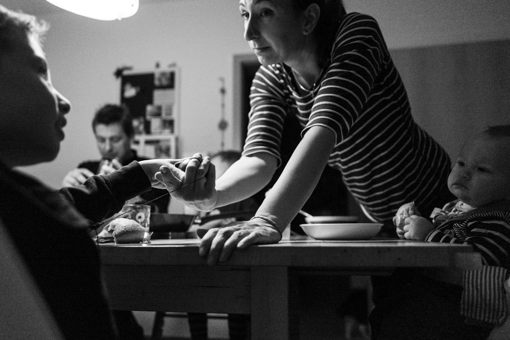 mother scolds child at dinner table