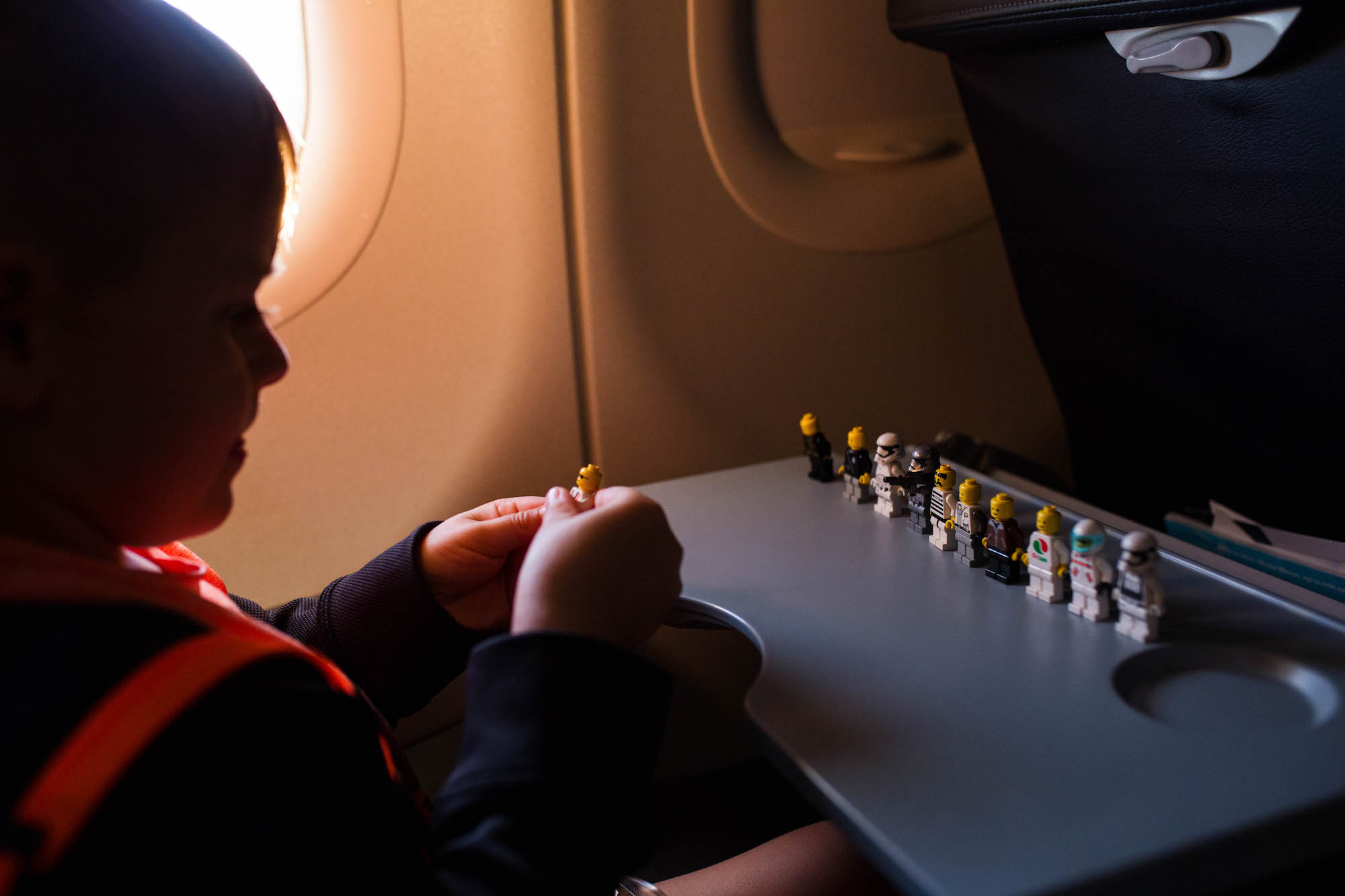 boy with legos on airplane - Documentary Family Photography