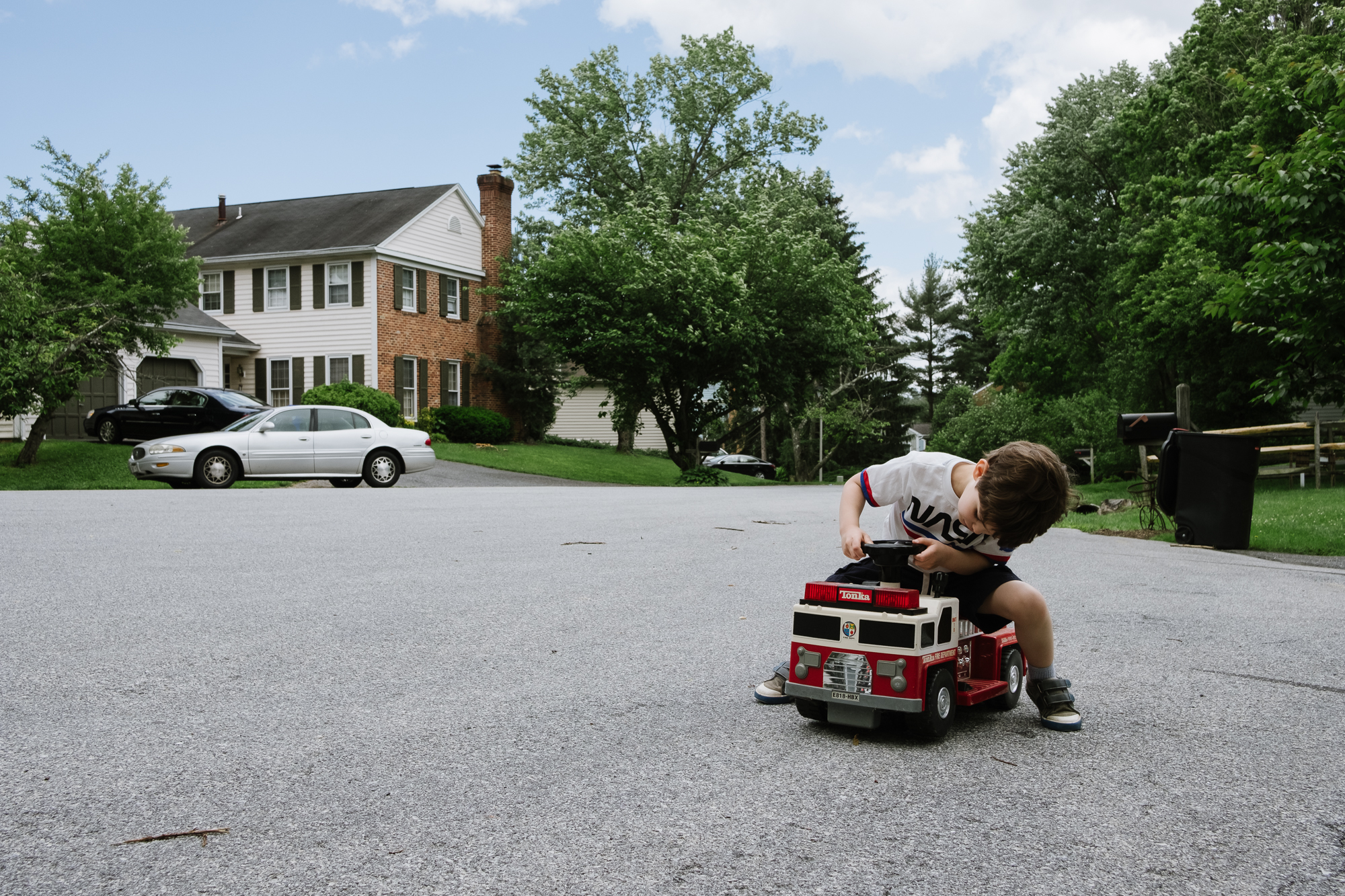 boy with power wheels in culdesac - Documentary Family Photography
