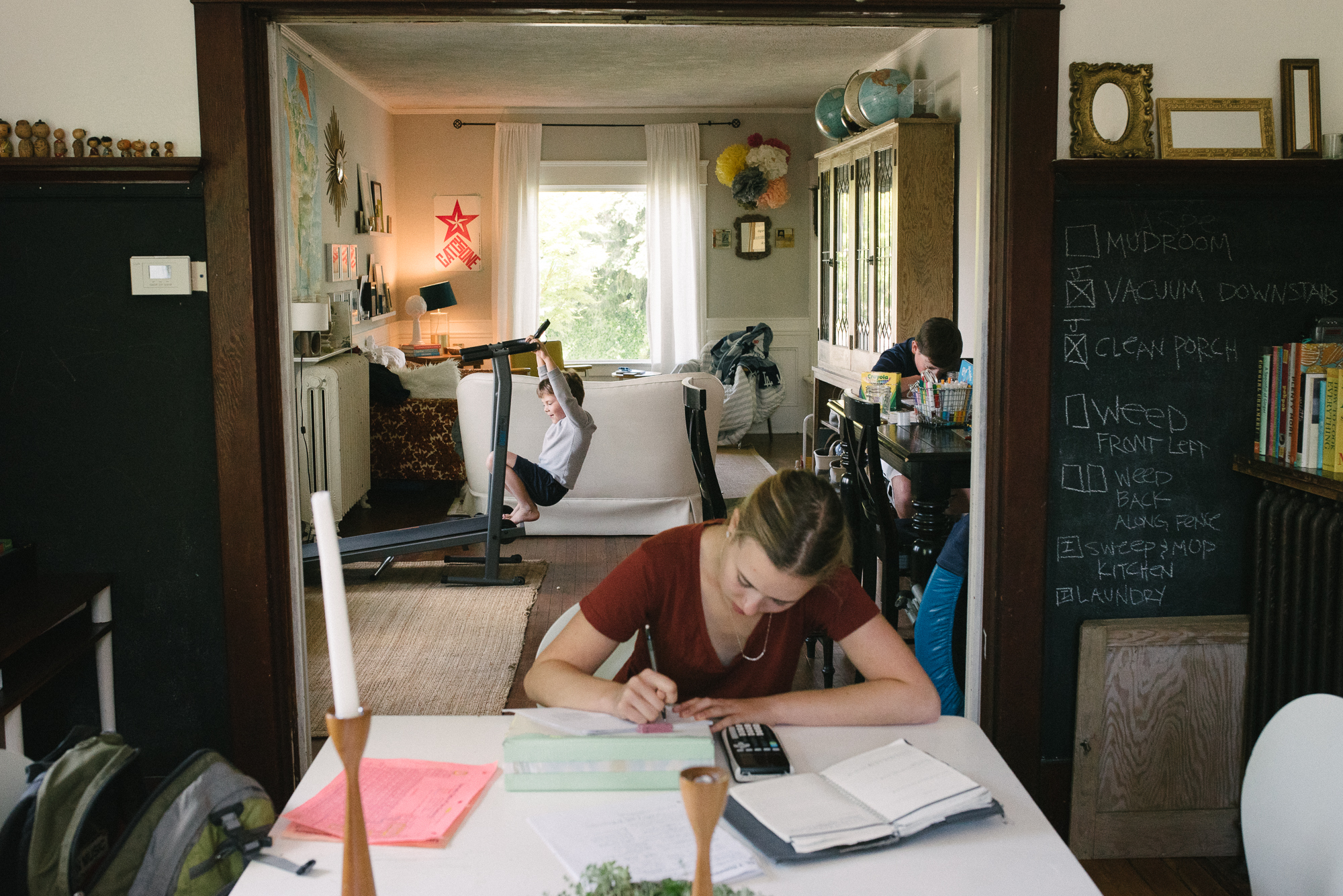 girl does homework in home - Documentary Family Photography
