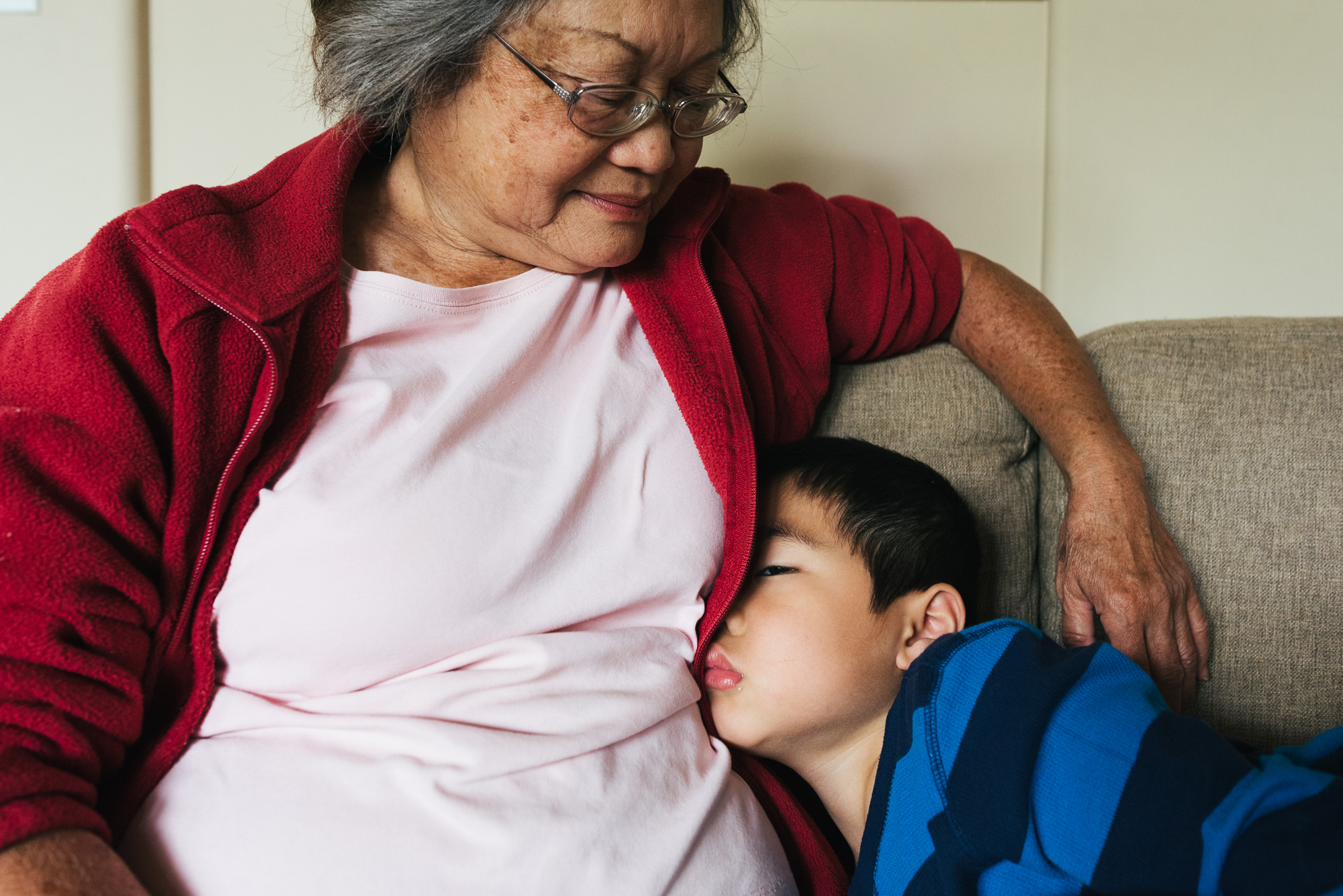 boy asleep with grandma - Documentary Family Photography