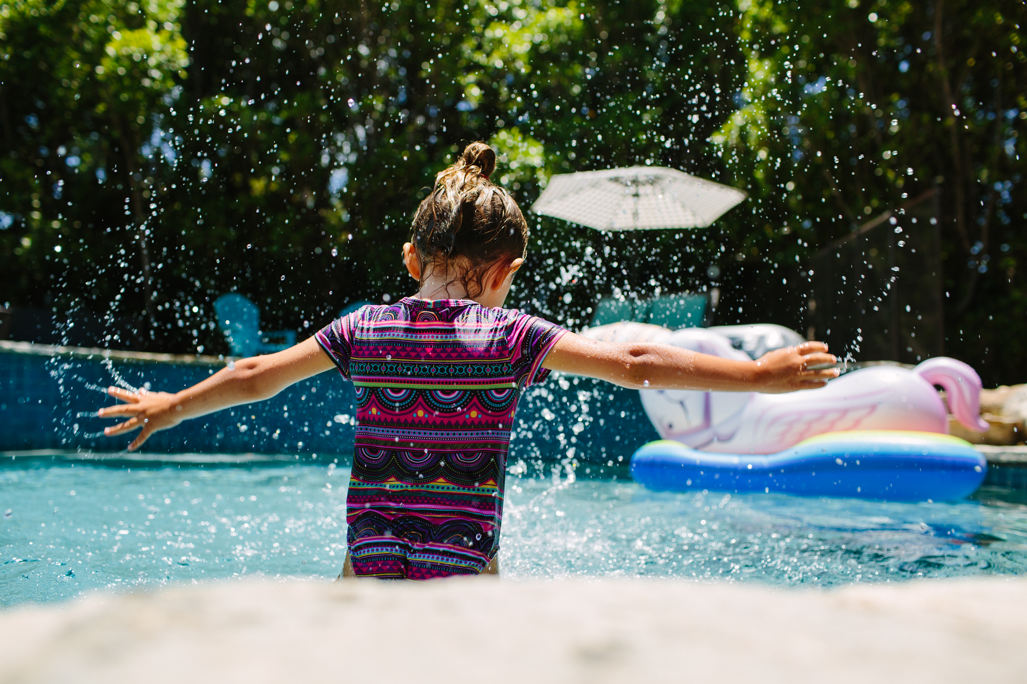 girl jumps in water - Documentary Family Photography