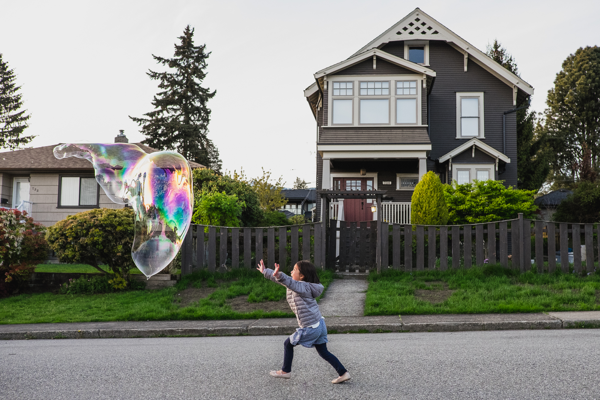 girl chases giant bubble - documentary family photography